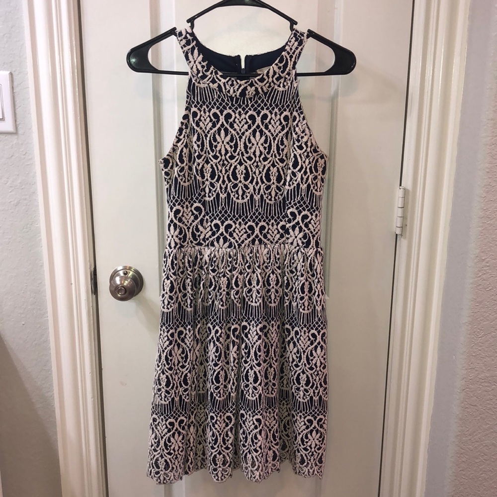 A navy dress w/ white embroidery and a sheer back